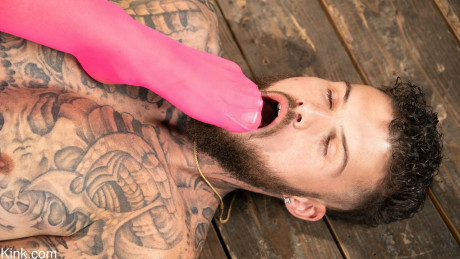 Inked babe in pink latex April Olsen whips & mounts a tattooed boy man man in bondage - #907229