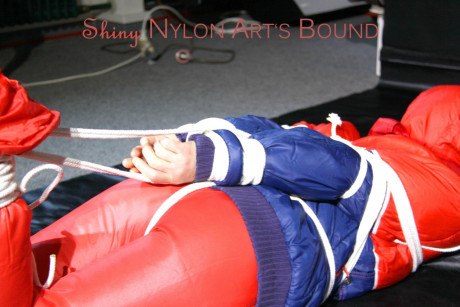 Caucasian lady woman is left tied, gagged and hooded on a sheet of black plastic - #1336108