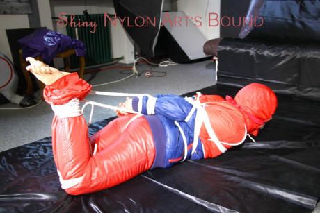 Caucasian lady woman is left tied, gagged and hooded on a sheet of black plastic - #1336110