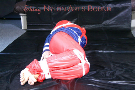 Caucasian lady woman is left tied, gagged and hooded on a sheet of black plastic - #1336111