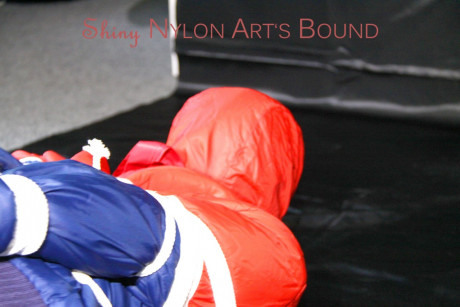 Caucasian lady woman is left tied, gagged and hooded on a sheet of black plastic - #1336120