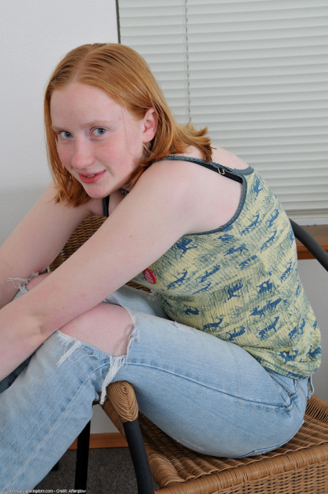 Amateur young Sandy strips and fingers her bushy muff while sitting on a rug