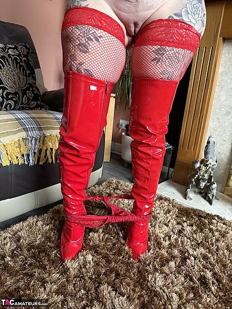 Tattooed blondy Inked MILF takes off red latex boots in red leggings - Image 7 of 16  in Pussy category   featuring Inked MILF 