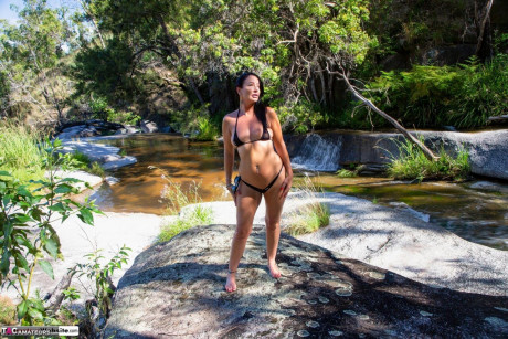 Brunette MILF Roxeanne undoes her bikini top while in a stream - #1321900