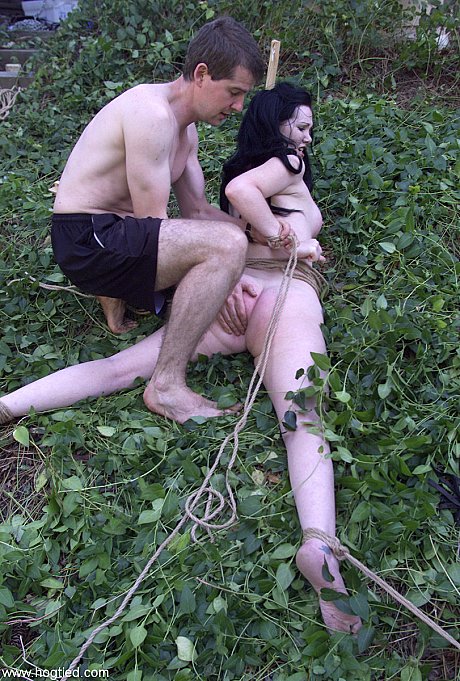 Dark-haired babe Paige Richards gets tied up spread naked in the back yard