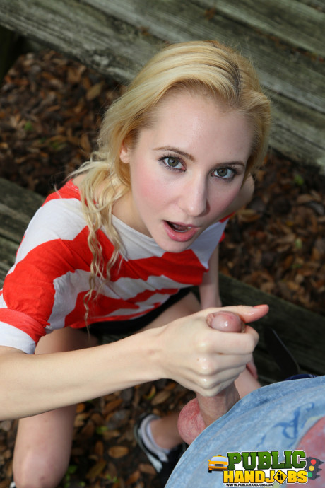 Blondie Odette Delacroix shows her tiny tits while giving a handjob outdoors