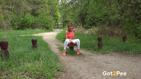 Red Hair Dafne squats to piss on woodland path