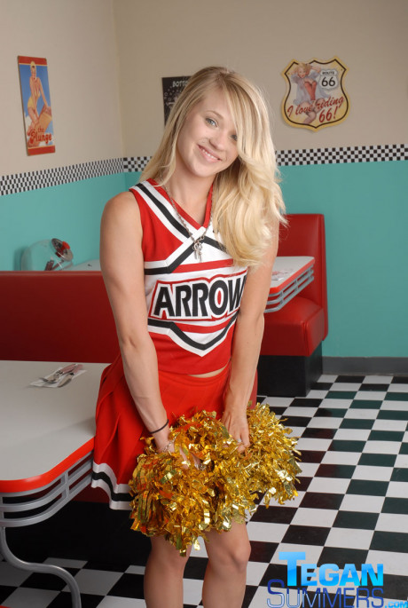 Sweet college yellow-haired Tegan Summers poses in a cheerleader outfit at a diner