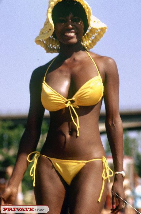 Ebony female in a bikini and sun hat heads into the woods to get undressed - #1093443