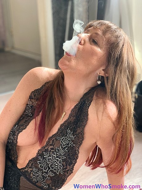 Badass cougar girl poses in her undergarment while smoking a cigarette - Image 13 of 15  in Non Nude category   featuring Pandora Smith 