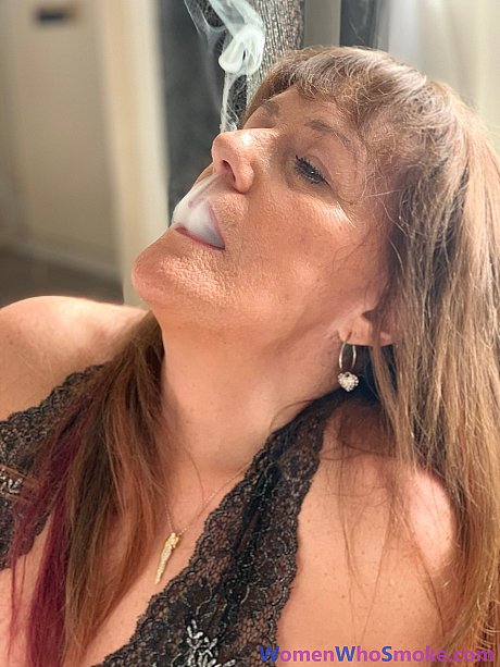 Badass cougar girl poses in her undergarment while smoking a cigarette - Image 14 of 15  in Non Nude category   featuring Pandora Smith 