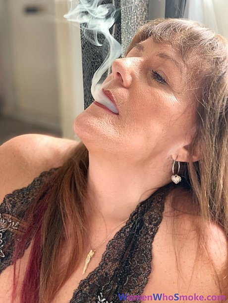 Badass cougar girl poses in her undergarment while smoking a cigarette - Image 15 of 15  in Non Nude category   featuring Pandora Smith 