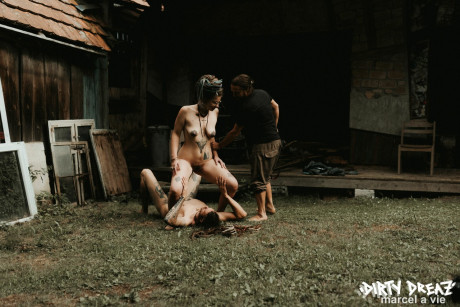 Heavily tattooed skanks piss on a naked boy boy stud outside the back steps of a house - #846987