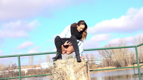 Cynthia Vellons squats on a tree stump to piss - #307350