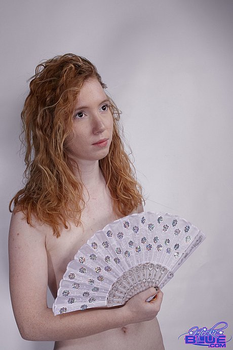 Natural ginger head Nicki Blue fans herself while modeling for a undressed solo shoot - Image 13 of 15  in Babe category   featuring Nicki Blue 