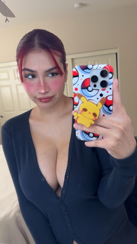 Redheaded honey Angel reveals her big tits and large nips up close