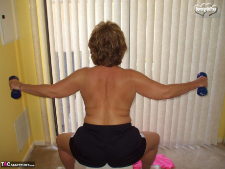 Middle-aged amateur Busty Bliss displays her enormous breasts during a home workout - #1084702