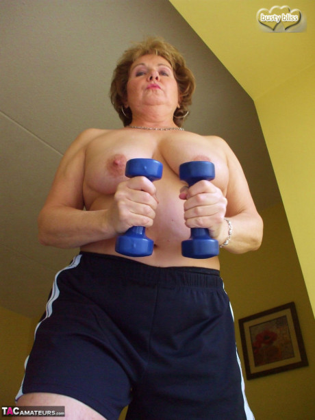 Middle-aged amateur Busty Bliss displays her enormous breasts during a home workout - #1084707