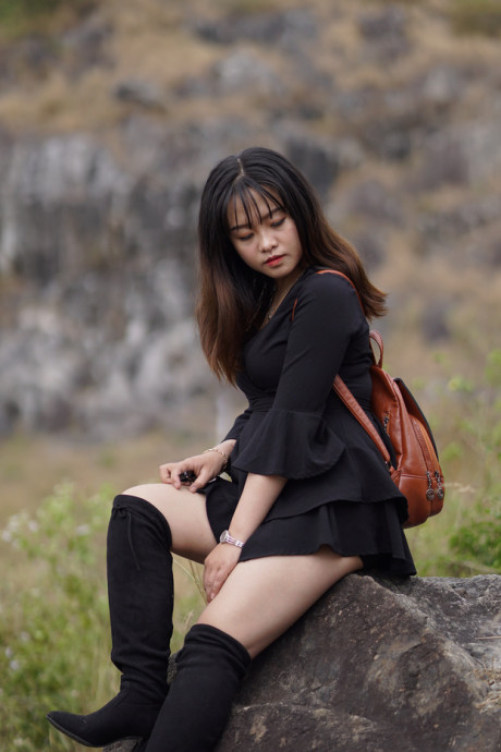 Pretty asian babe posing in her black dress and boots in nature - #1100116