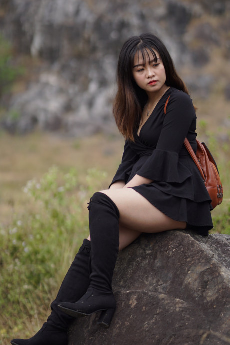 Pretty asian babe posing in her black dress and boots in nature - #1100118