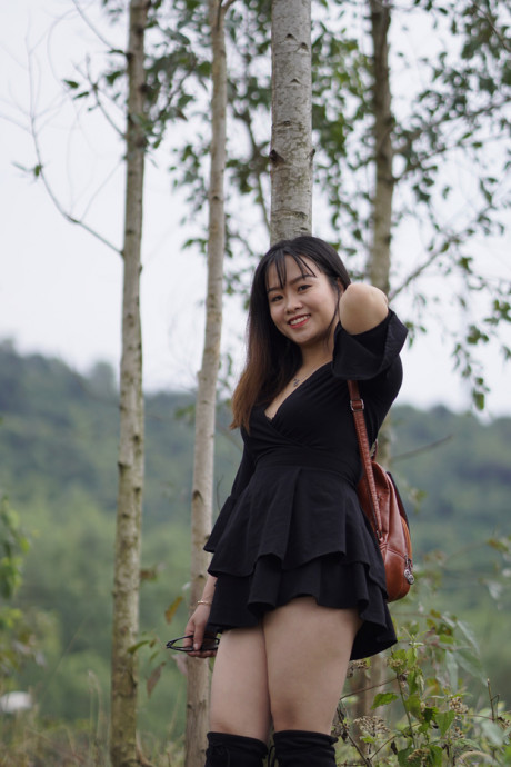 Pretty asian babe posing in her black dress and boots in nature - #1100122