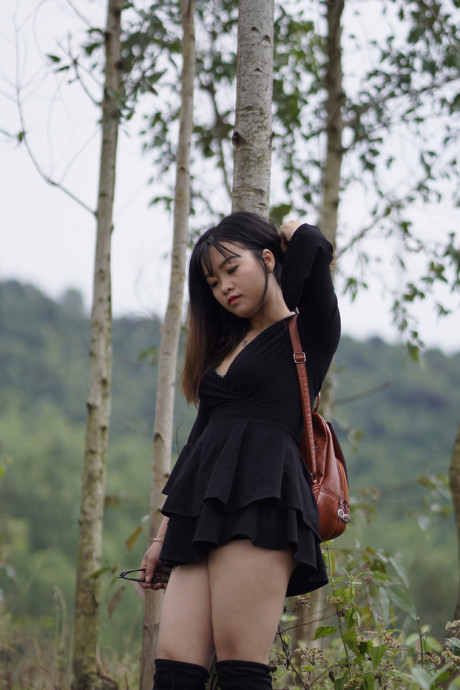 Pretty asian babe posing in her black dress and boots in nature - #1100123