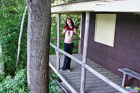 Cute redheaded bitch GF lady teenie Satine uncovers her small boobies on a rustic porch