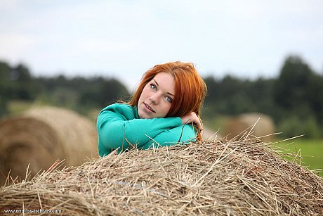 Natural redhead Amber A poses her nude teen body on round bale of hay - Image 1 of 16  in Pussy category   featuring Amber A 