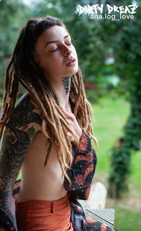 Tattooed female Cutz sports dreadlocks while showing her tiny breasts