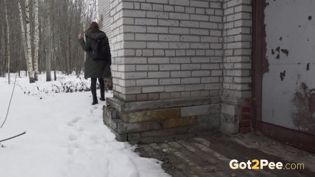 Caucasian skank gf chick Valya takes a piss next to a building during the winter