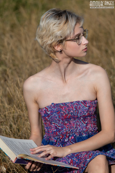 Nerdy female ditches her book and glasses before getting naked in a field - #425173