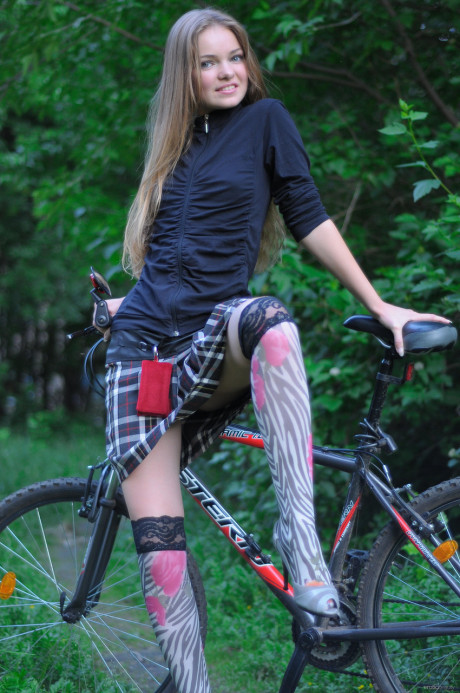 Ravishing teen babe Bridgit A riding her bicycle pantyless in nature - #622749