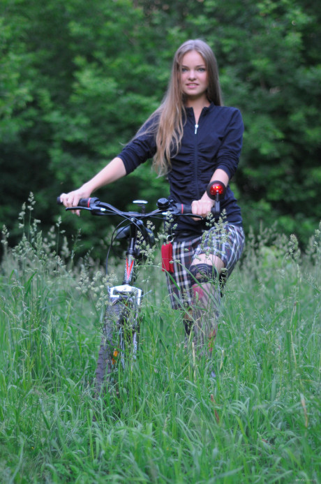 Ravishing teen babe Bridgit A riding her bicycle pantyless in nature - #622768