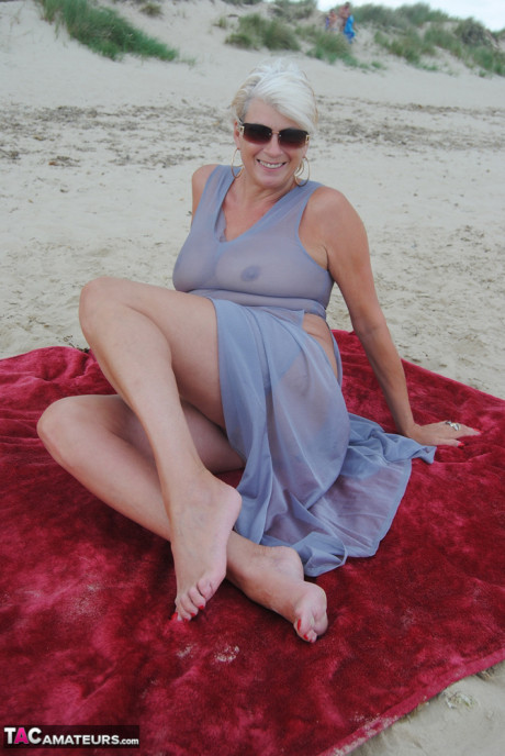 Stunning busty older Dimonty poses fully clothed in sheer dress at the beach - #1328389