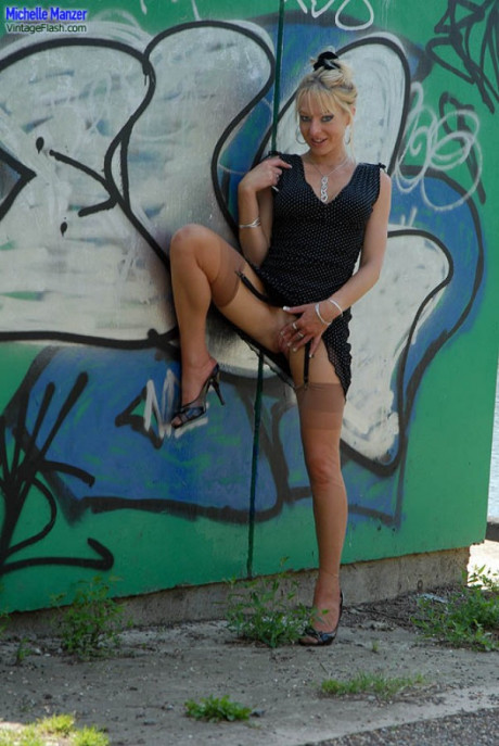 Bubbly blonde Michelle Manzer suns her bald pussy on a bench in nude upskirt - #1527470