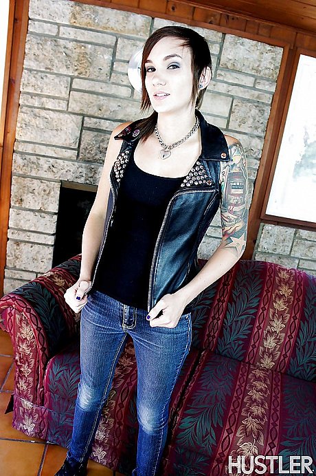 Short haired pornstar Nikki Hearts posing fully clothed in denim jeans