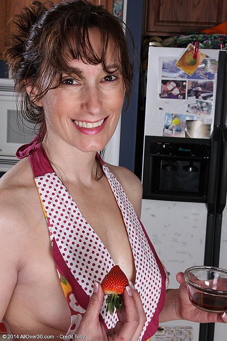 Middle-aged chick woman Celeste Carpenter takes off her apron to pose nude in kitchen