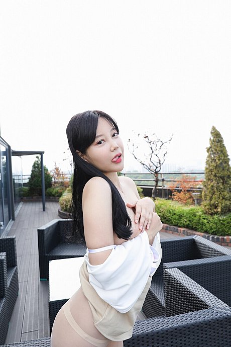Oriental beauty steps out onto a rooftop balcony during an upskirt tease display - Image 10 of 10  in Model category  