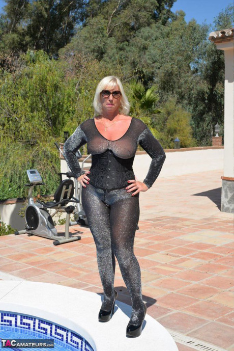 Aged amateur Melody takes off her heels before a swim in a bodysuit and shades - #928117