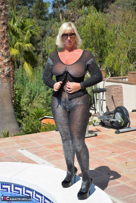 Aged amateur Melody takes off her heels before a swim in a bodysuit and shades - #928120