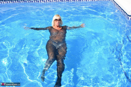 Aged amateur Melody takes off her heels before a swim in a bodysuit and shades - #928130