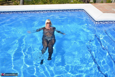 Aged amateur Melody takes off her heels before a swim in a bodysuit and shades - #928131