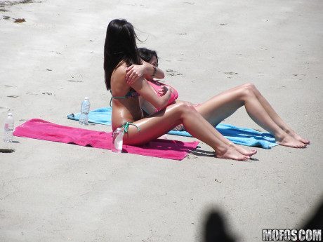 Sassy brunettes get caught on voyeur video having some fun on the beach - #502349