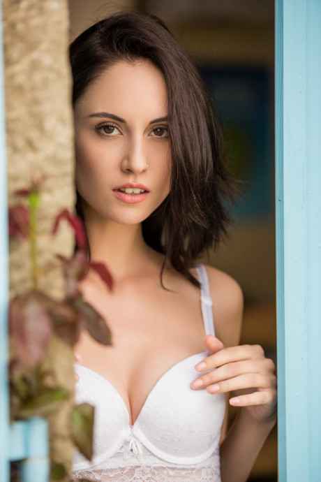 Slender Italian doll Sade Mare poses seductively in her white bra in the door - #695074
