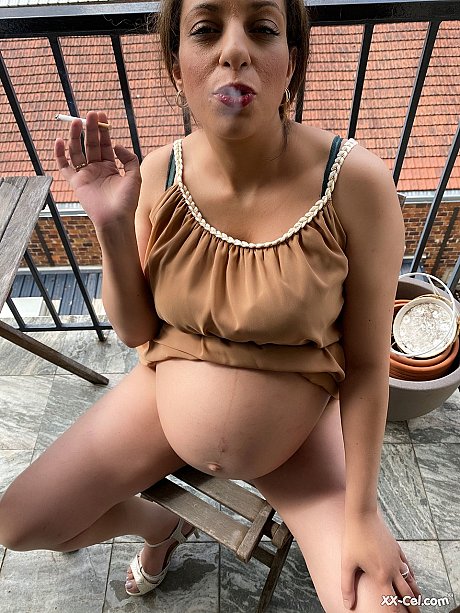 Pregnant smoker Leila teasing undressed with her bulging tummy & her dark nipples - Image 6 of 20  in Close Up category   featuring Leila 
