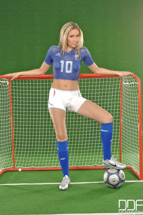 European teen Cherry Jul poses in a body-painted uniform on a soccer field - #996445