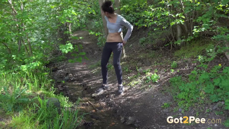 Dark haired Esperansa pees into a woodland stream - #269466