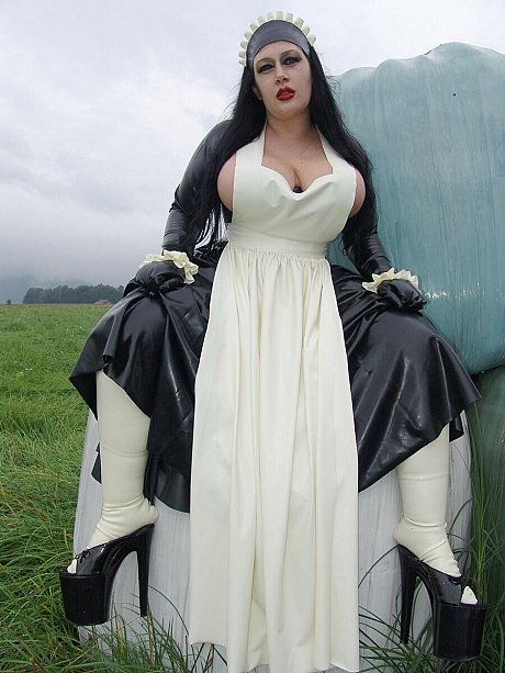 Goth woman girl lady Angelina does her laundry outdoors in a tub in latex clothing - Image 2 of 16  in Outdoor category   featuring Lady Angelina 
