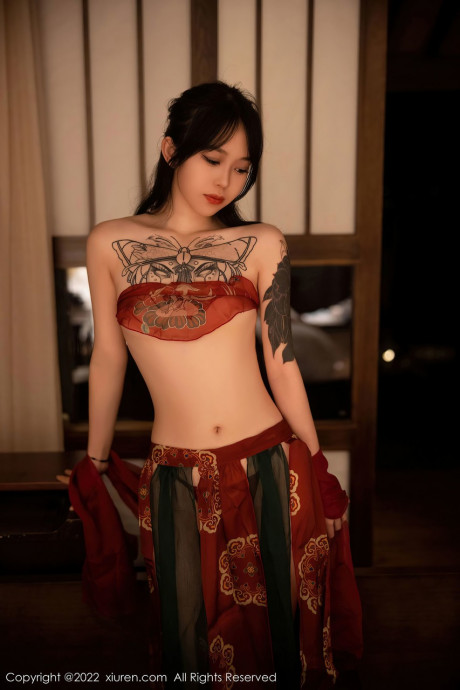 Seductive asian dancer Xiuren poses in her hot dress in a solo