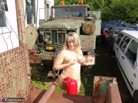 Middle-aged blonde attractive Susi goes nude in red latex boots at the wrecker's - #1105537